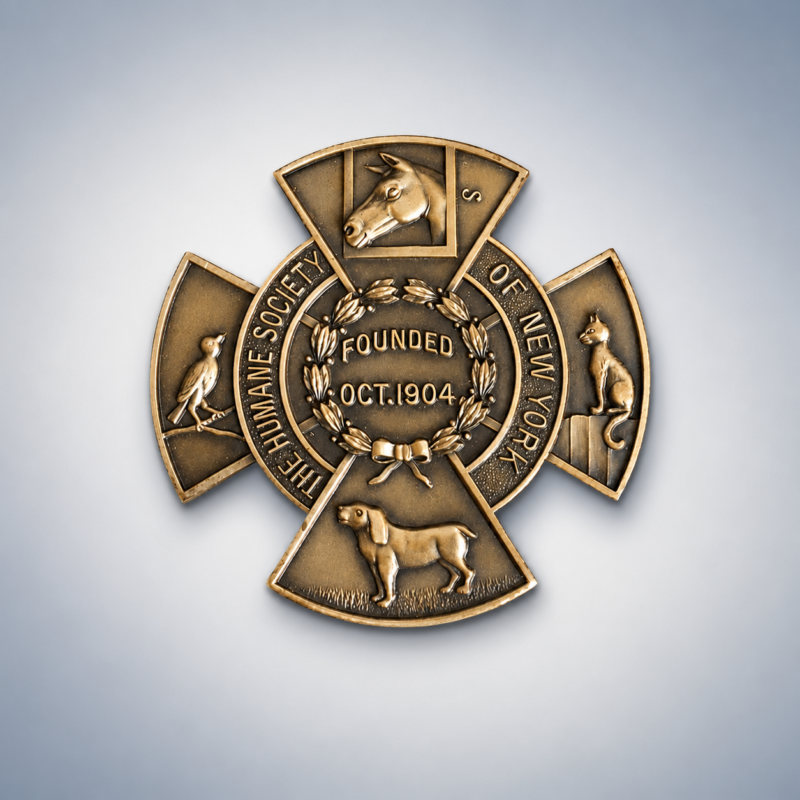 HSNY humane medal - bronze emblem featuring a horse head, bird, dog and cat.